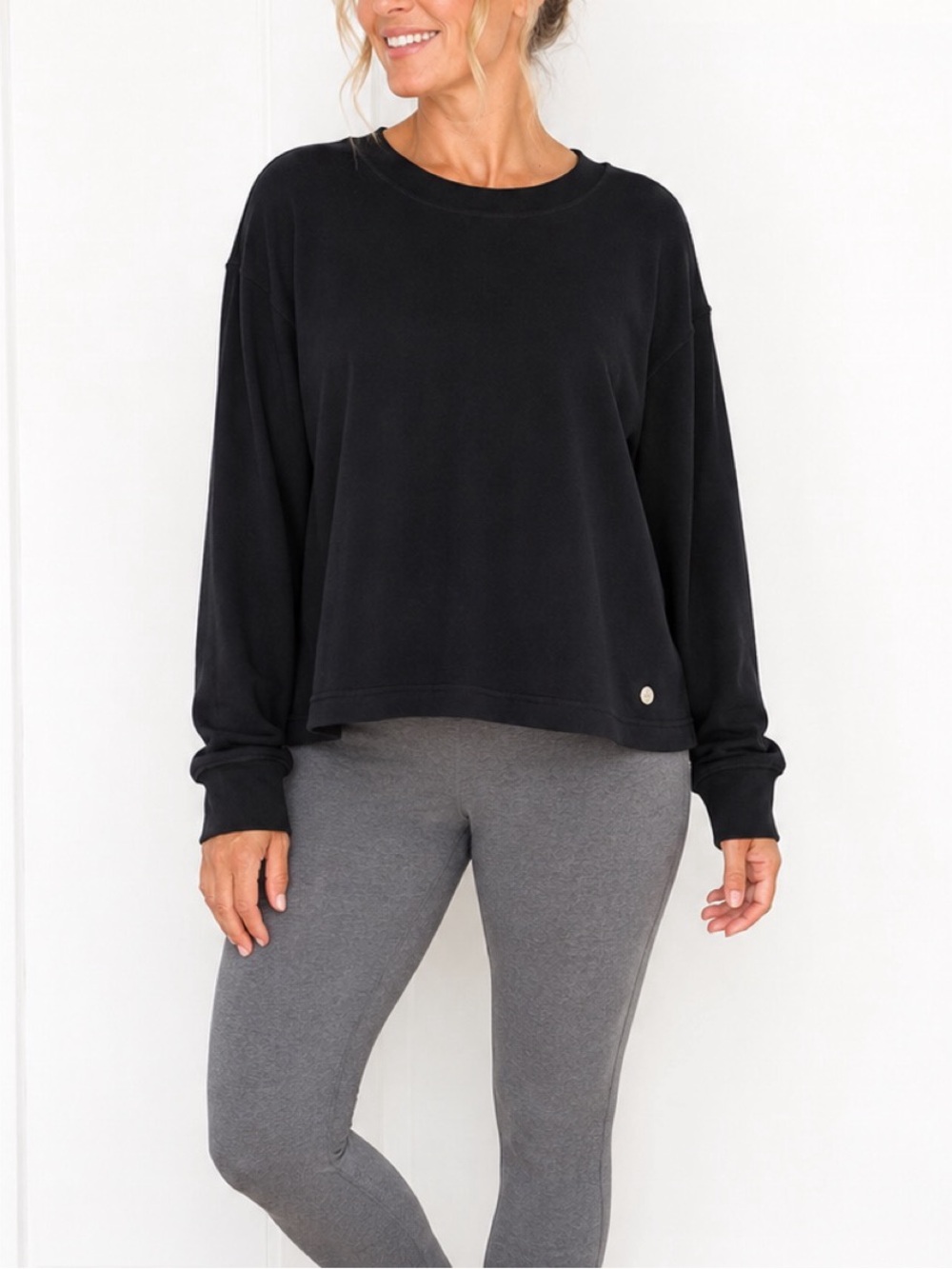 Apana black top featuring a crew neckline, long sleeves with fitted cuffs, XL